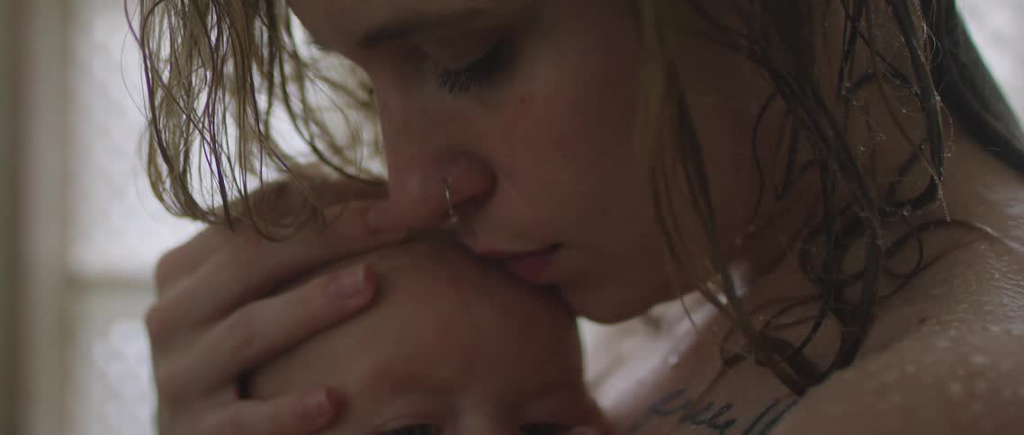 A woman and a baby standing together