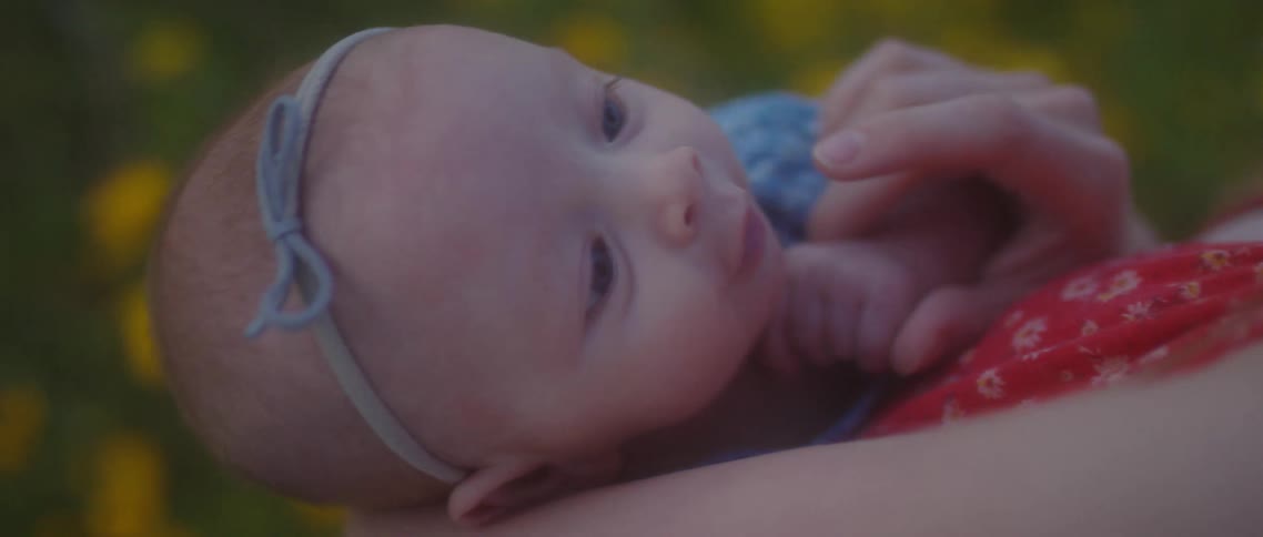 A woman holds and rocks her infant daughter