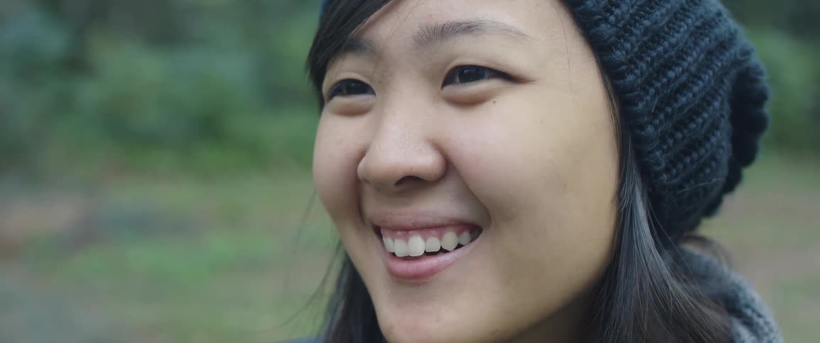 A young woman smiling outside