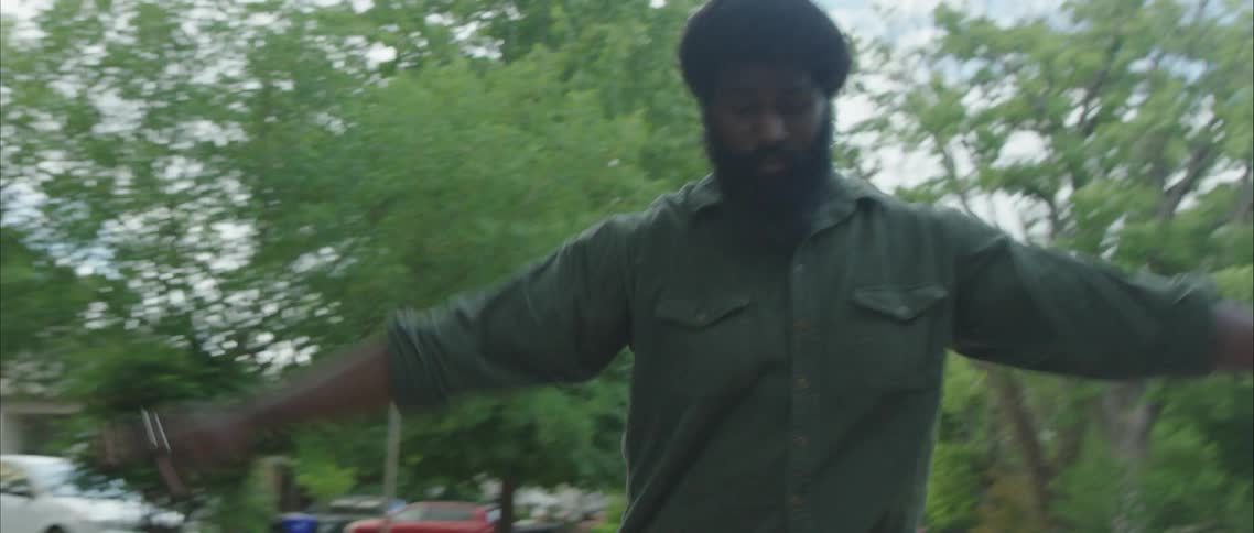 A man dancing in a neighborhood street