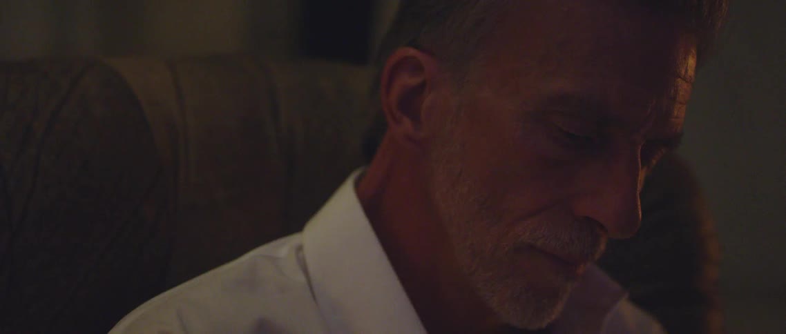 A man sitting in a chair in a home