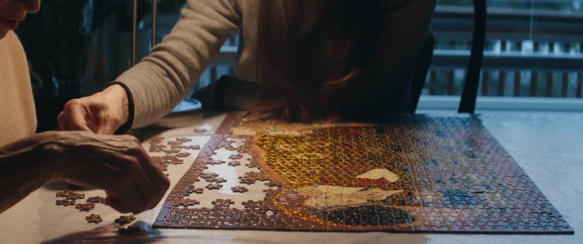 Two people working on a puzzle