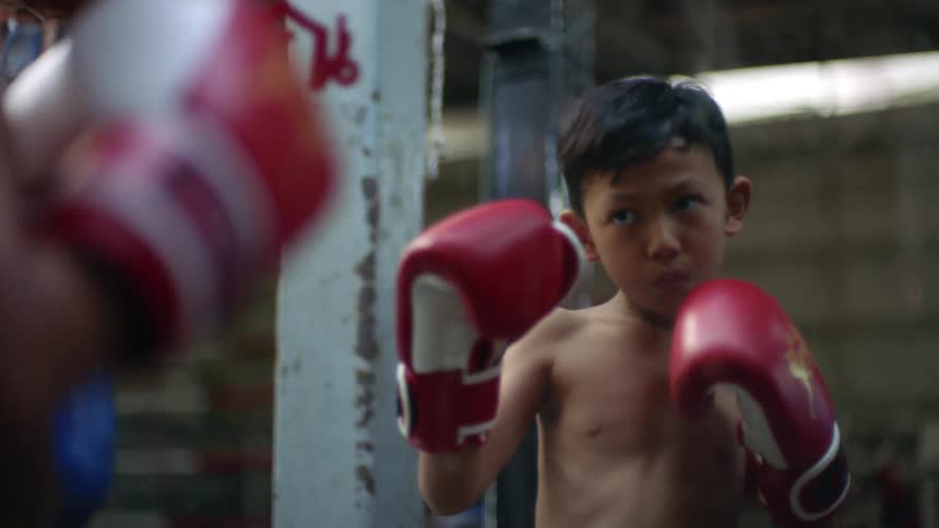 A child practicing boxing