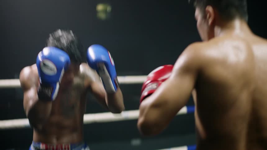 Two men engaged in a boxing match