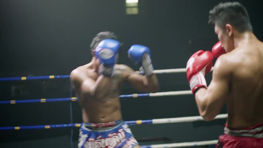 Two men are boxing each other in a ring