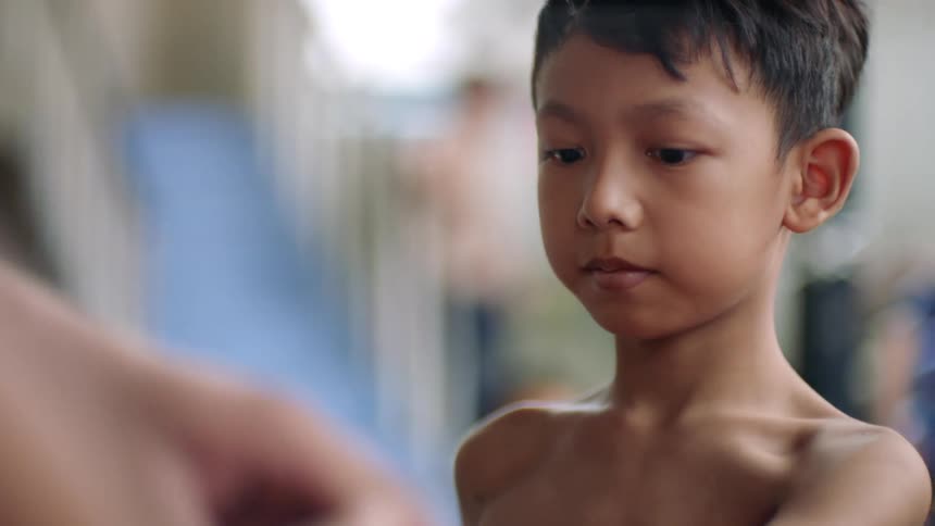 A child having gloves be put on