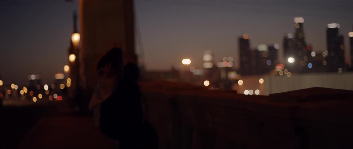 A woman dancing in front of a city skyline