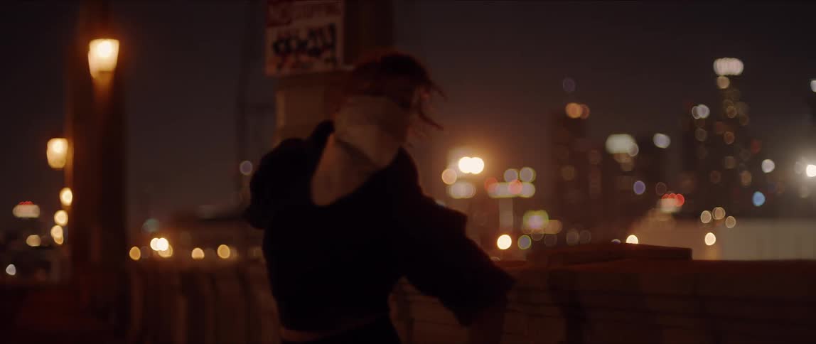 A woman with a mask dancing with buildings and the sky in the background