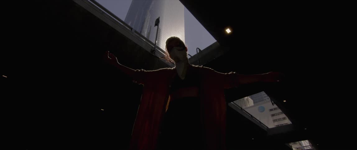 A woman dancing and blocking the suns reflection in a building