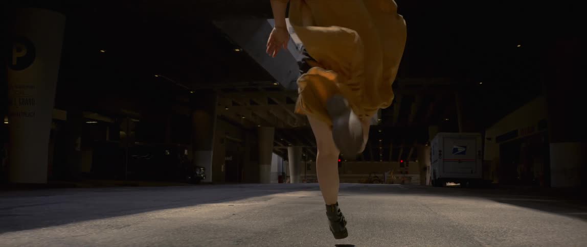 White woman running alone in the middle of a parking lot
