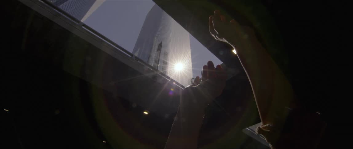 A person blocking the refection of the sun with their hands