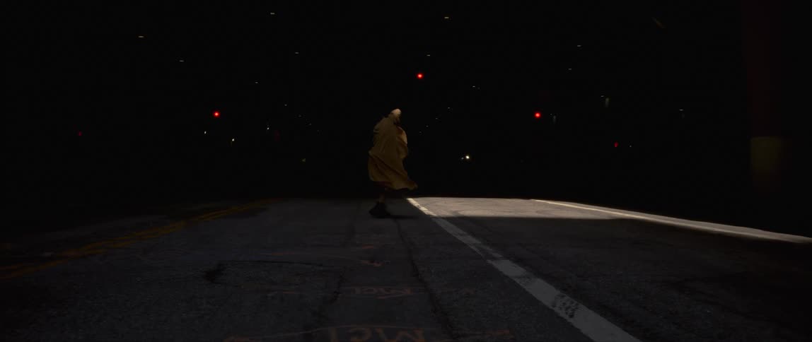 A woman dancing in a dark room with an open roof