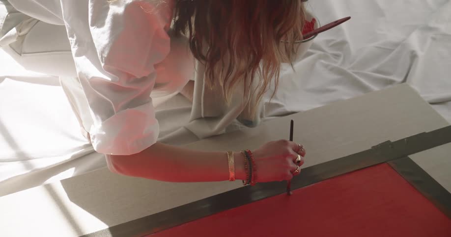 A woman painting on a canvas