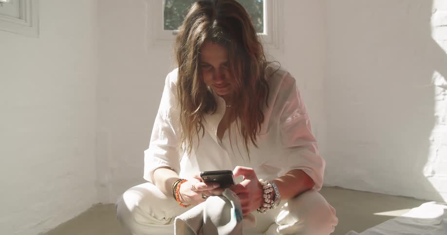 A woman squatting on a phone