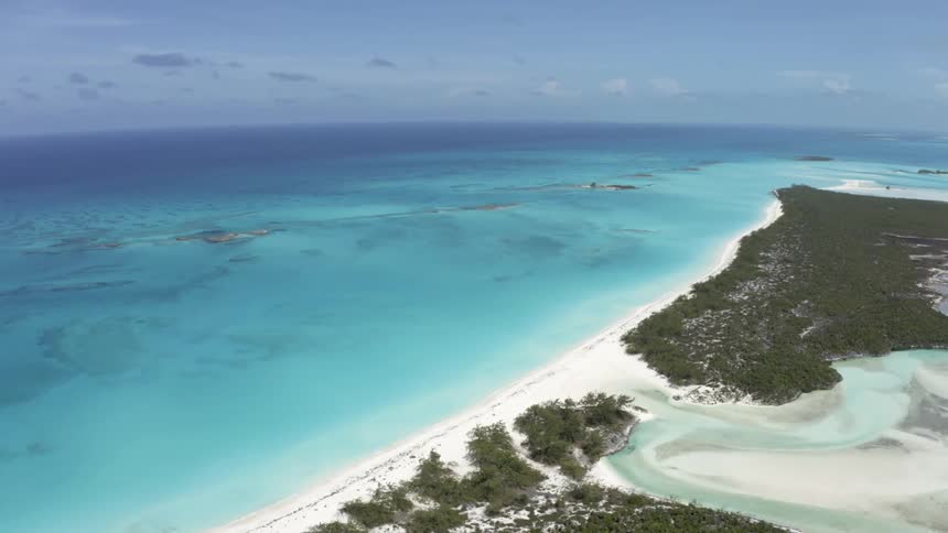 The long sandy coast of a landmass on a sunny day