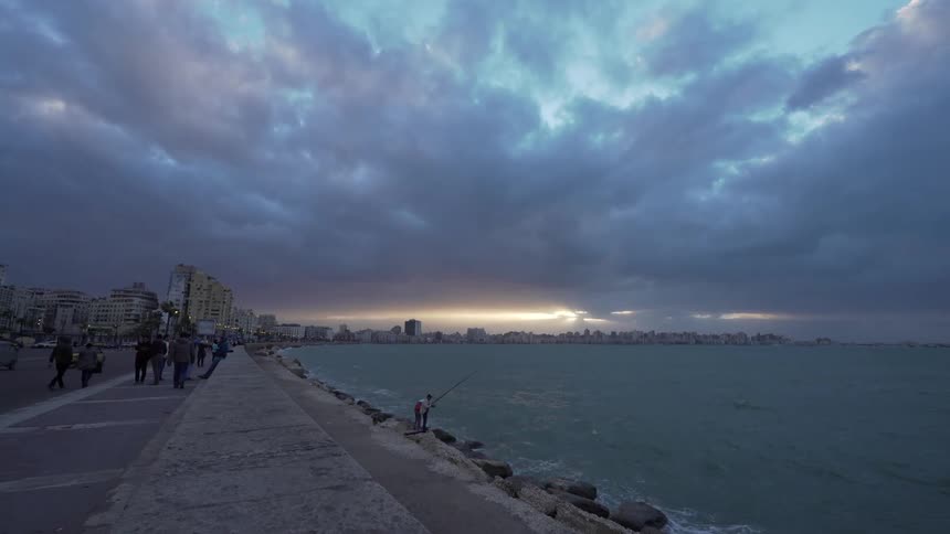 Shoreline on a big city with people walking on the sidewalk