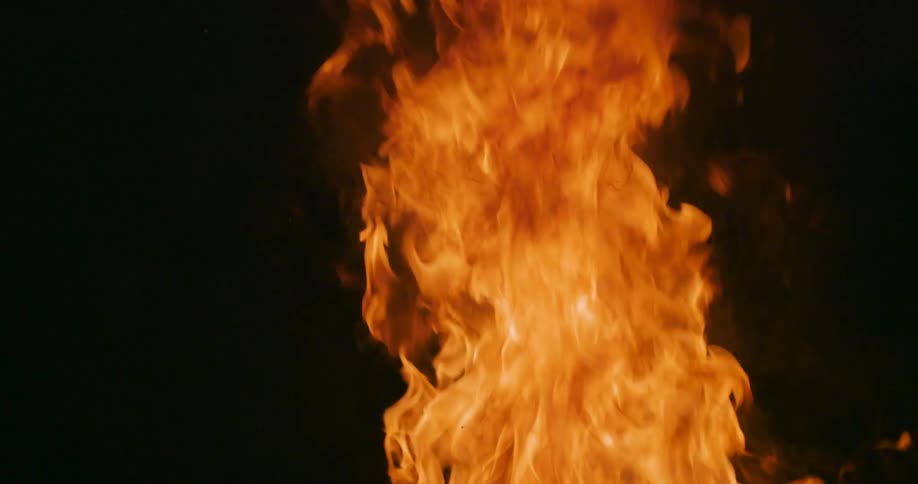 Orange flame contrasts with black surrounding