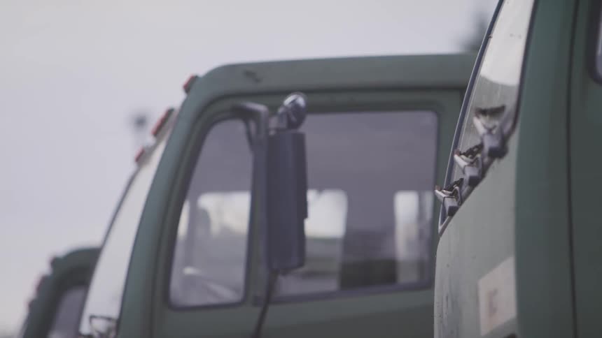 A close up of the fronts of trucks