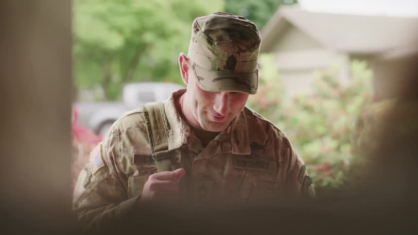 A military member in uniform returning home