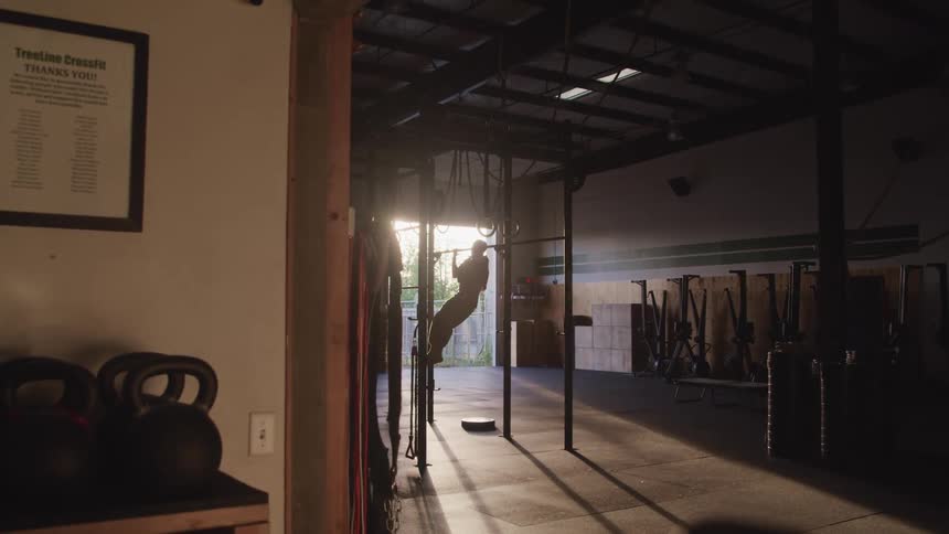 A person is exercising in a room during the day