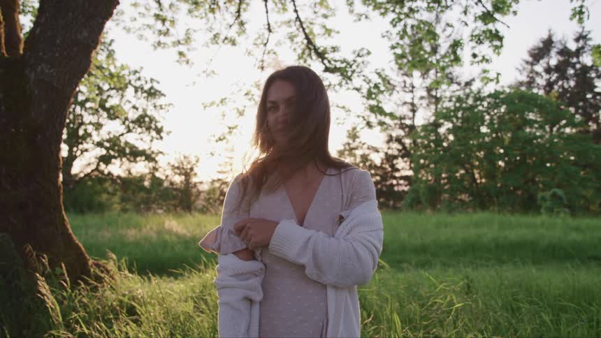 A young woman standing in a grassland
