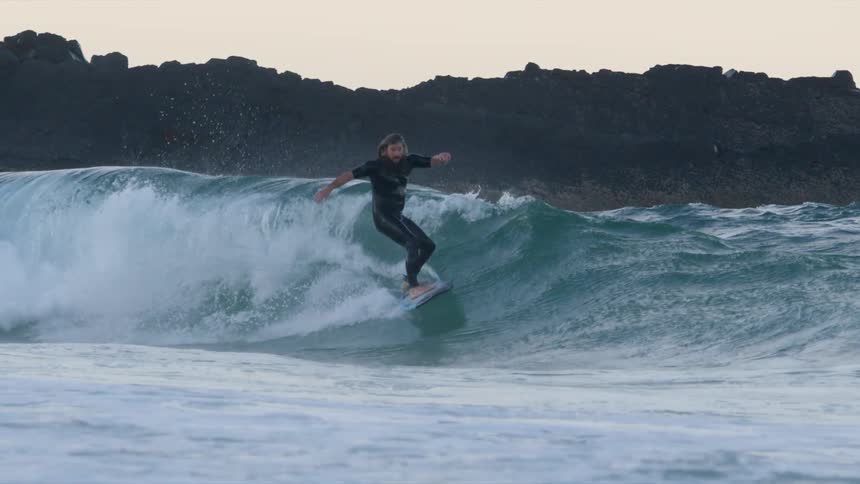 A man and woman surfing on waves in the ocean