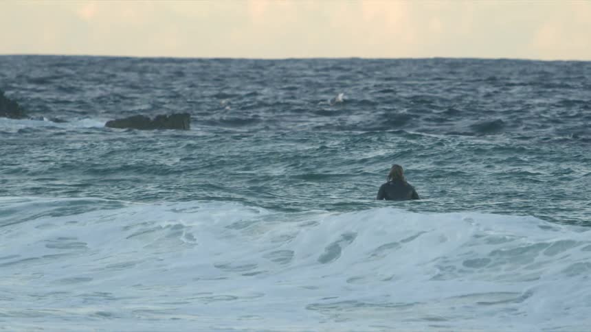 Person alone surfing at the sea
