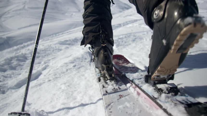 A person wearing skis moves in the snow
