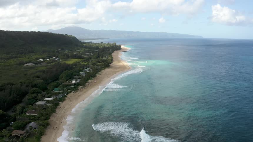 Aerial view of the mountains and coasts of an island on the blue ocean waters