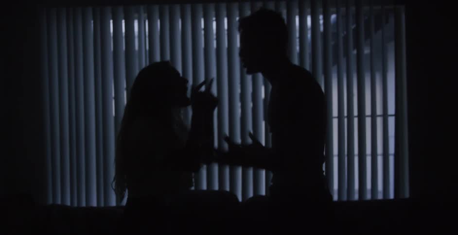 A couple are fighting in the dark room