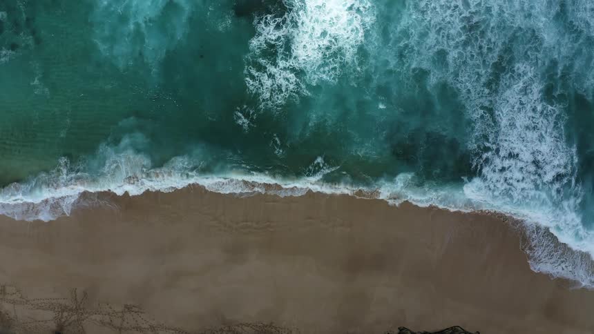 The waves crash against the shore