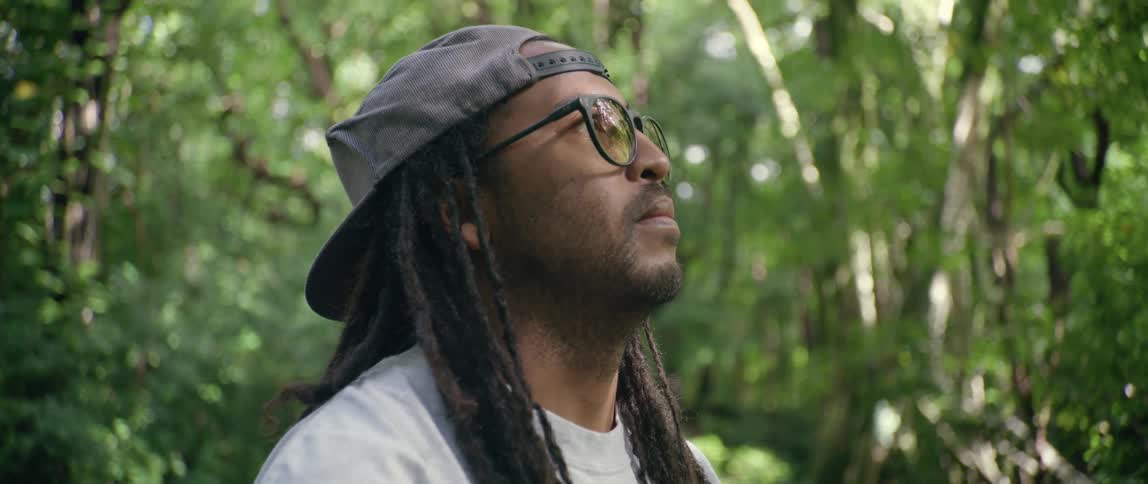 A man is standing in the middle of the forest