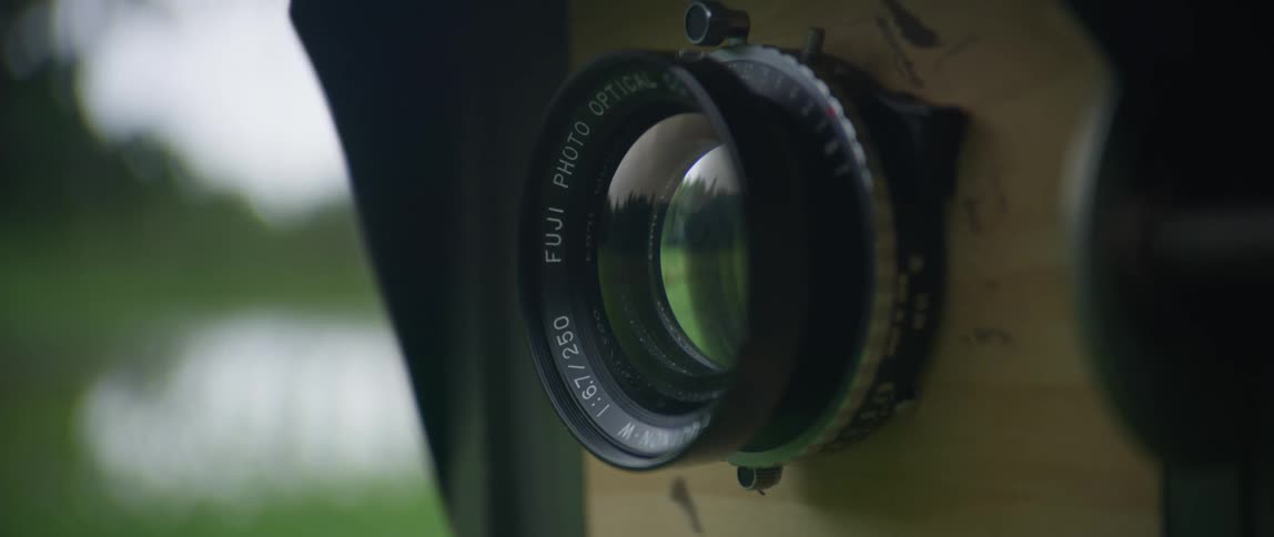 Camera lens reflects surroundings outdoors