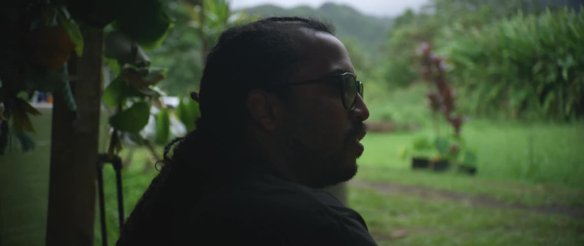 A man sitting looking into a yard
