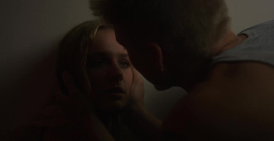 Couple exchange glances and man kisses woman on forehead
