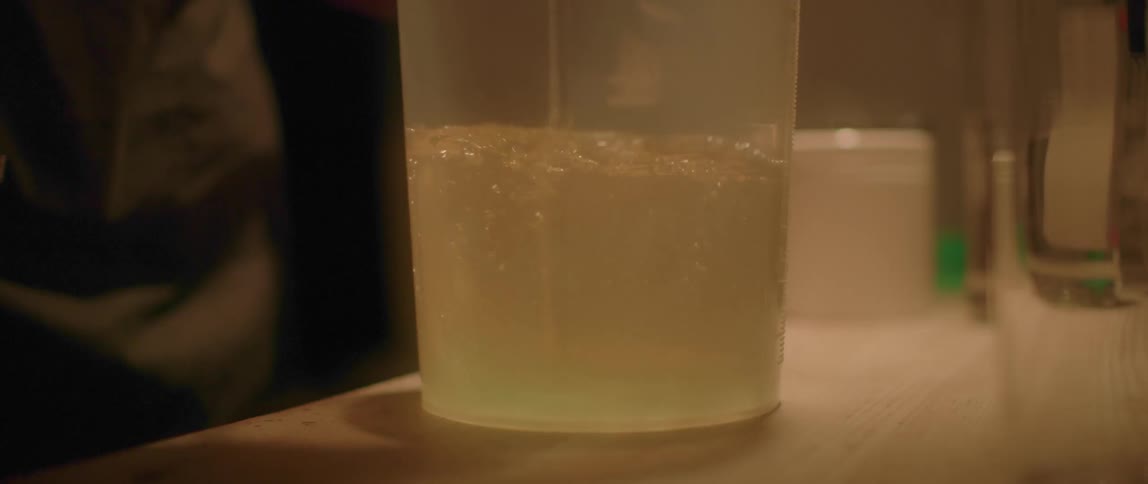A zooming shot of a glass being stirred
