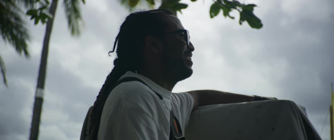 A man is standing outdoors on a cloudy day