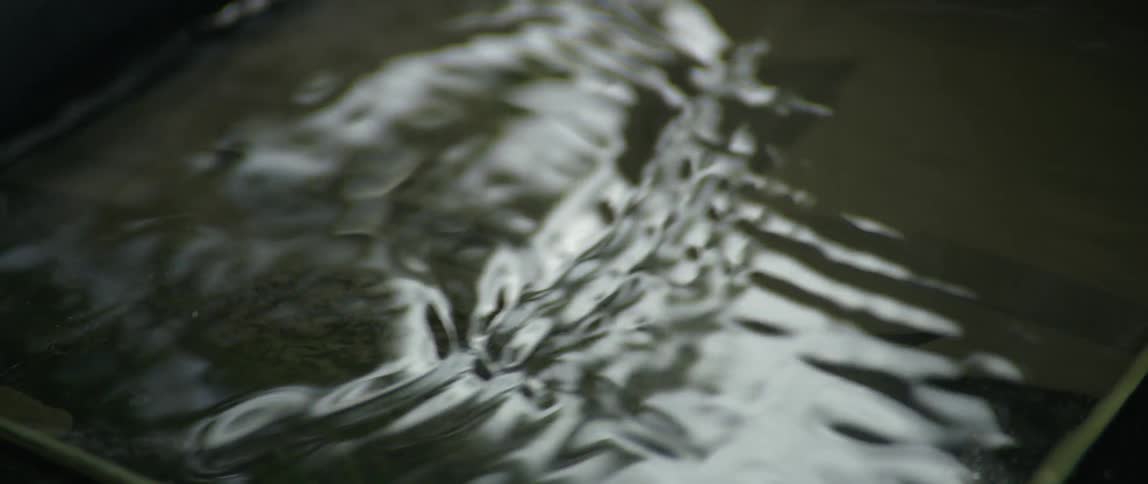 A clear liquid moves back and forth inside of a container