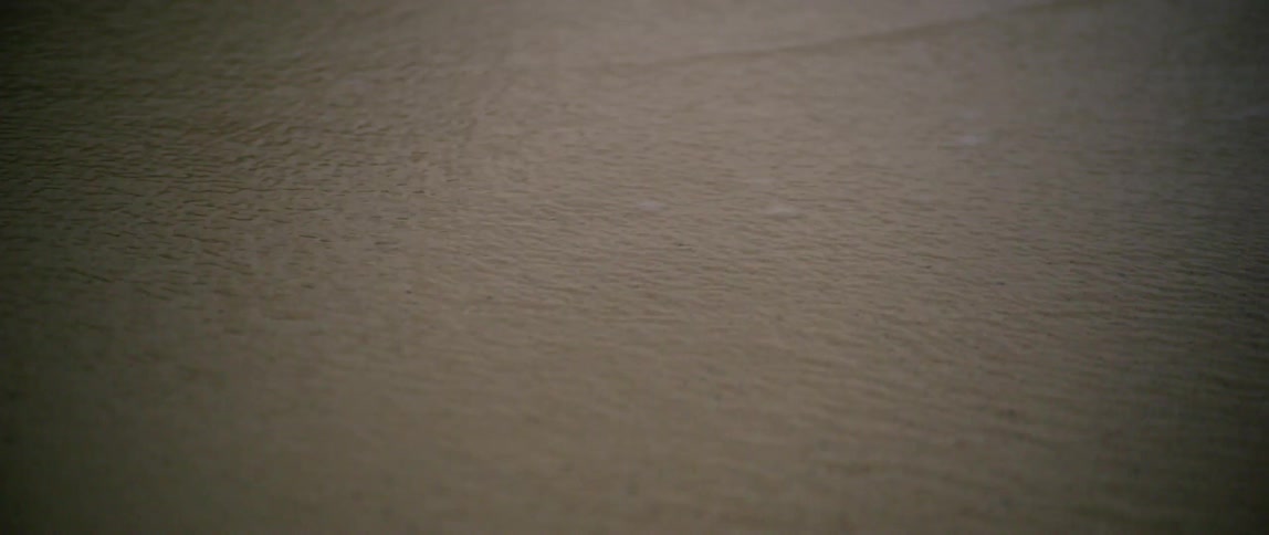 Thin layer of water flowing quickly over sand