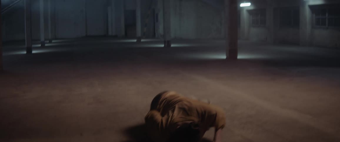 A woman is dancing in a building at night