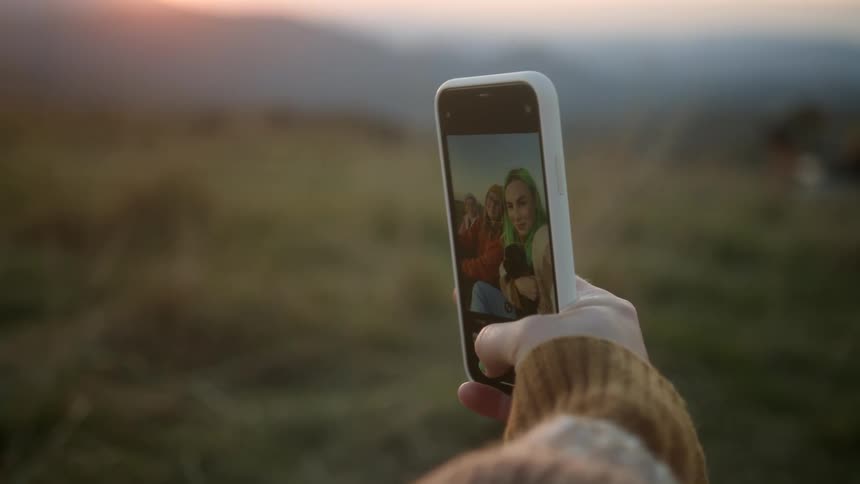 Two teenager girls taking a selfie on a cellphone