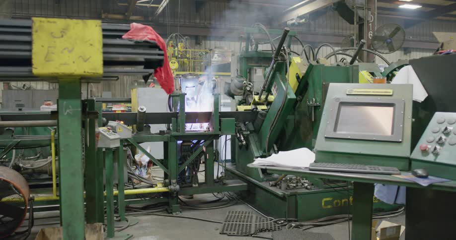 Sparks and smoke rise from damaged machinery in a factory