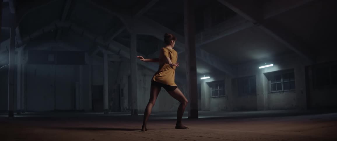 A woman is dancing in a building