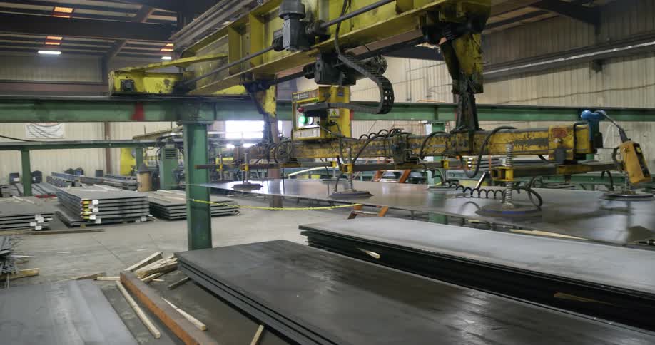 A machine moving a sheet of metal
