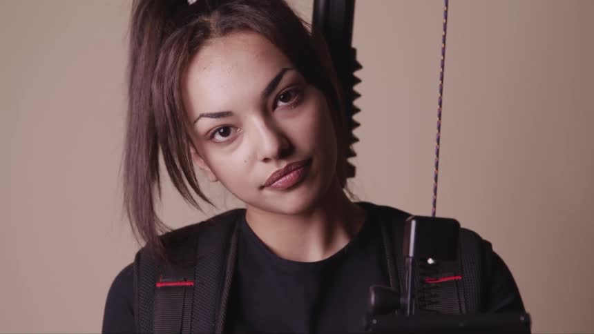 A woman standing and looking at a camera