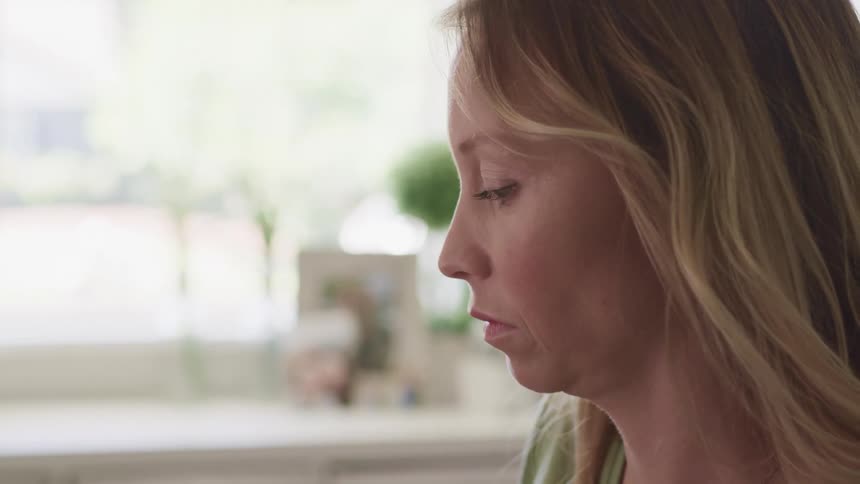 A woman looking around in her house