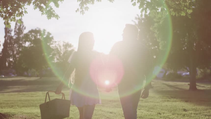 A man and a woman walking ina park