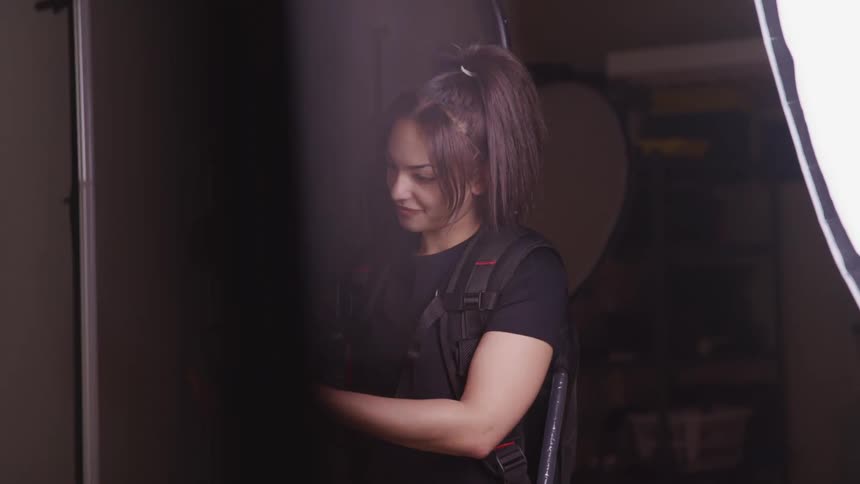 A photographer smiles as she takes photos