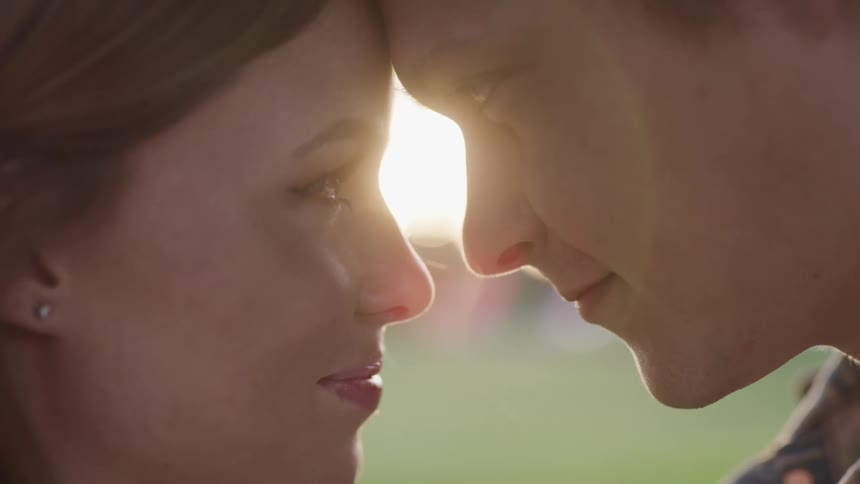 White couple closely facing each other in a romantic way