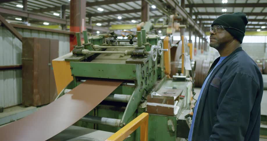 A man stands next to equipment while working
